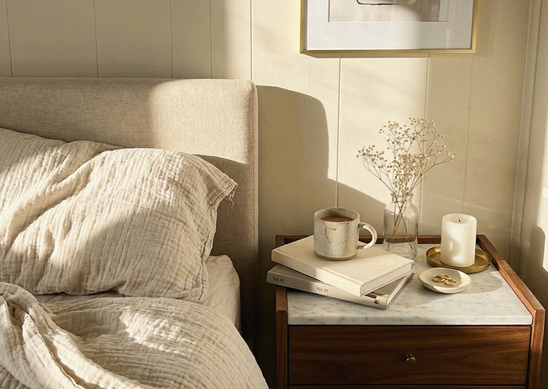 Cotton gauze sheets on a softly woen bed with summer light pouring in